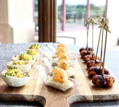 Passed appetizers on a wooden board