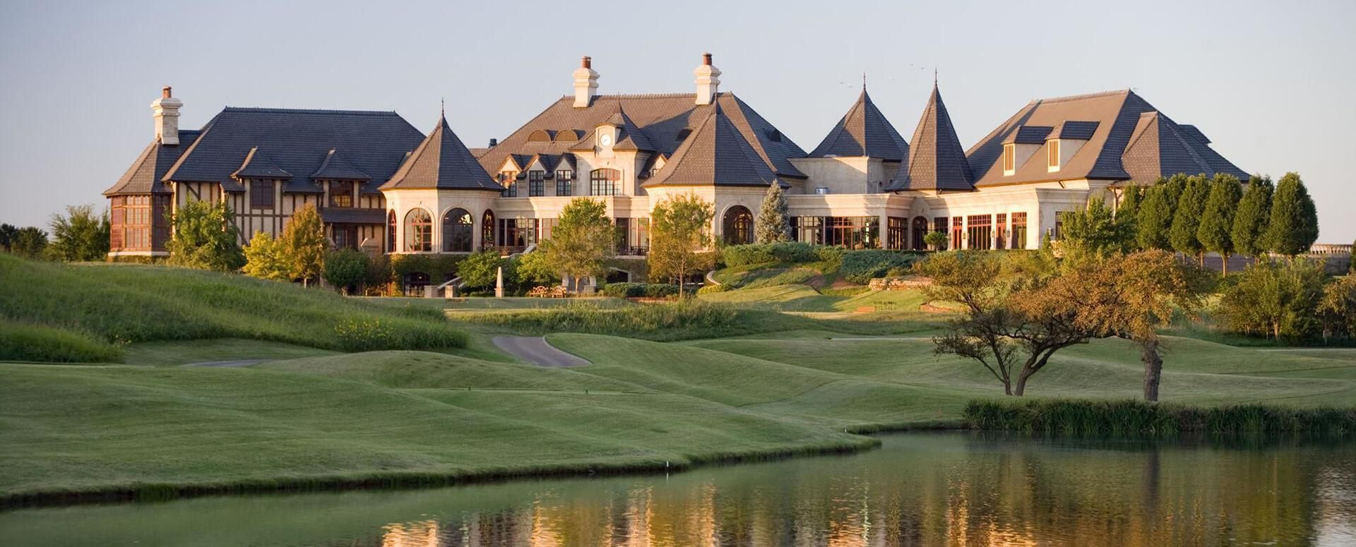 The Gaillardia Country Club clubhouse at sunset, across the lake